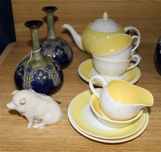 A pair of Royal Doulton Art Nouveau narrow neck bottle vases, a Belleek pig and a Susie Cooper yellow and white polka dot tete a tete,
